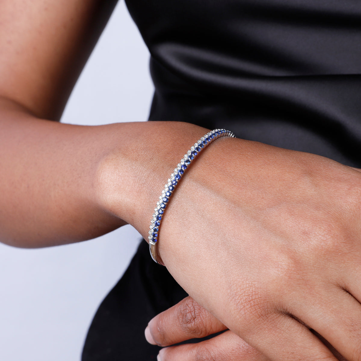 Two rows of round cut stones featuring diamonds and precious stones. Elevate any look.