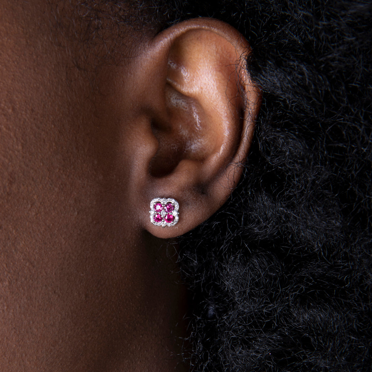 Inspired clover studs with precious stones allured with diamonds in a dazzling halo.