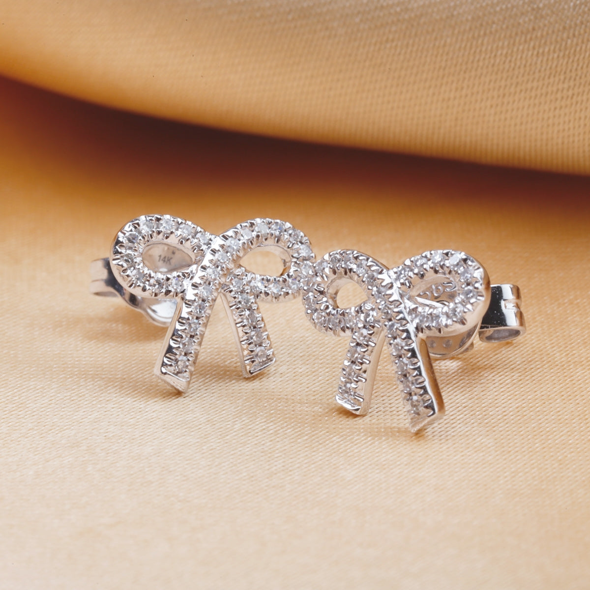 Simple and elegant bow studs with diamonds all around. Secure fitting, perfect for everyday. 