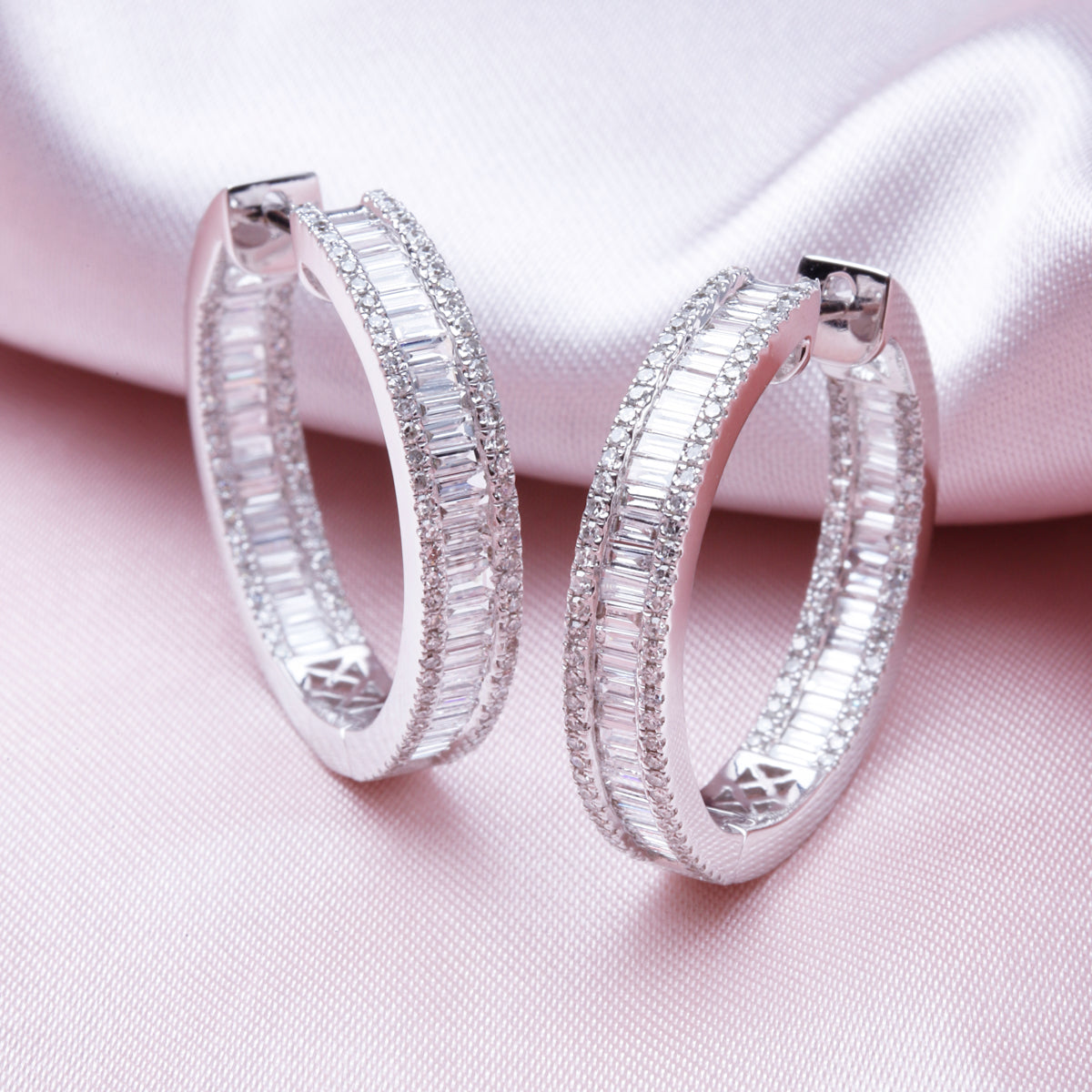 Versatile hoop, an inside-out style. Baguette diamond has been set on the inside. A modern look.