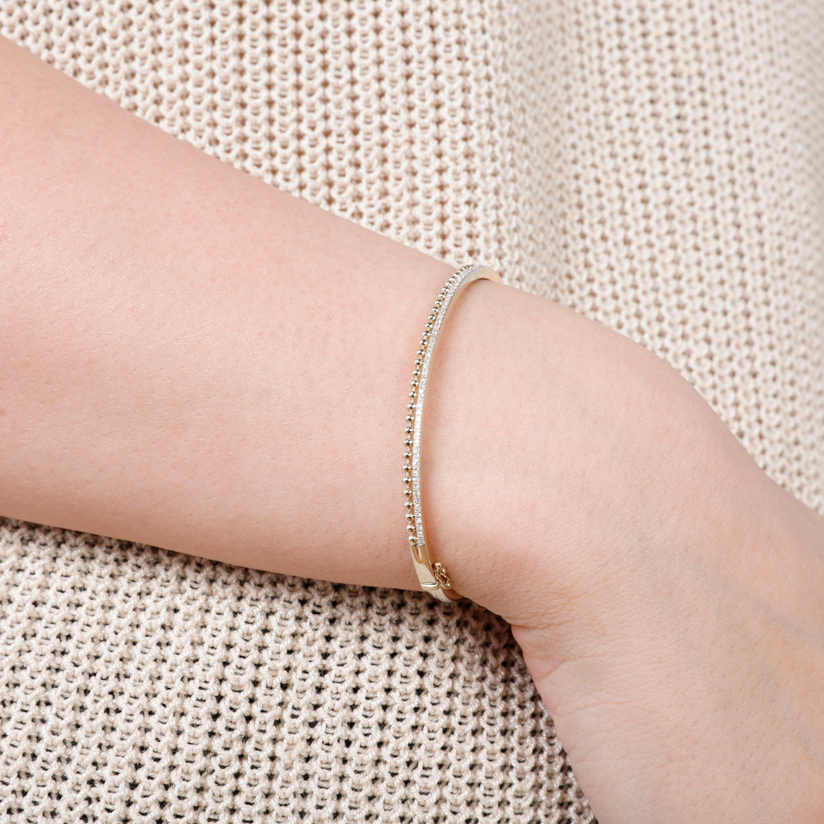 Beaded Gold Bangle features beaded accents that radiate classic charm. Add a touch of sophistication