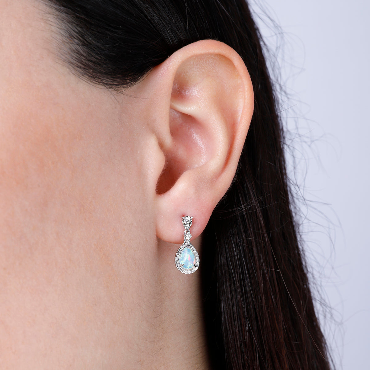 Opal Earrings in a dangle design with a diamond halo. Timeless and effortless beauty. 