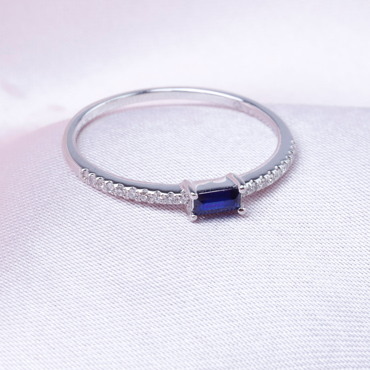 Baguette Stacking Ring has a diamond cluster on an eternity band. A variety of precious stones. 