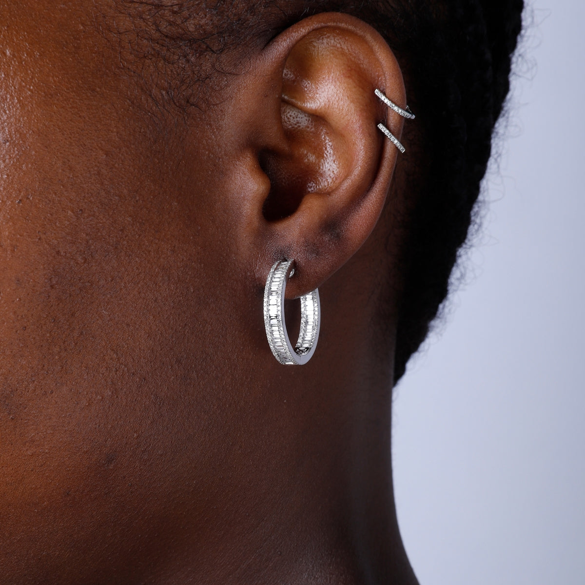 Versatile hoop, an inside-out style. Baguette diamond has been set on the inside. A modern look.