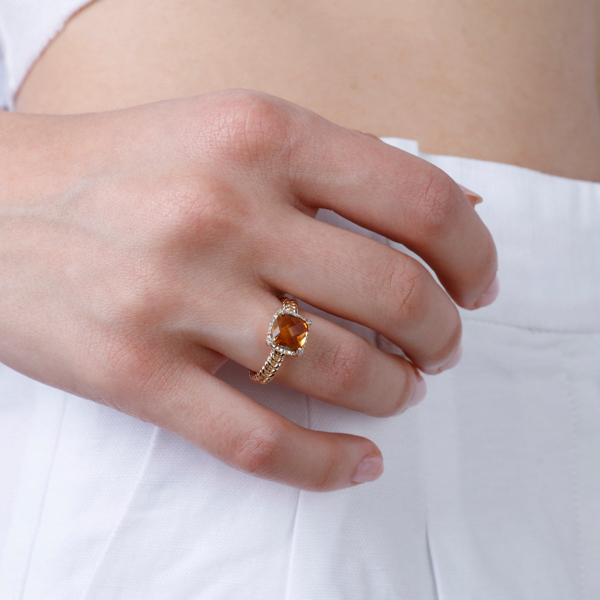 Braided Halo Ring, gemstone with a golden braided band symbolizing unity and strength. Modern twist.