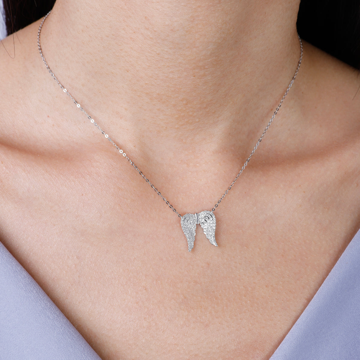 Angel Wings Necklace features handcrafted intricately detailed diamond angel wings.