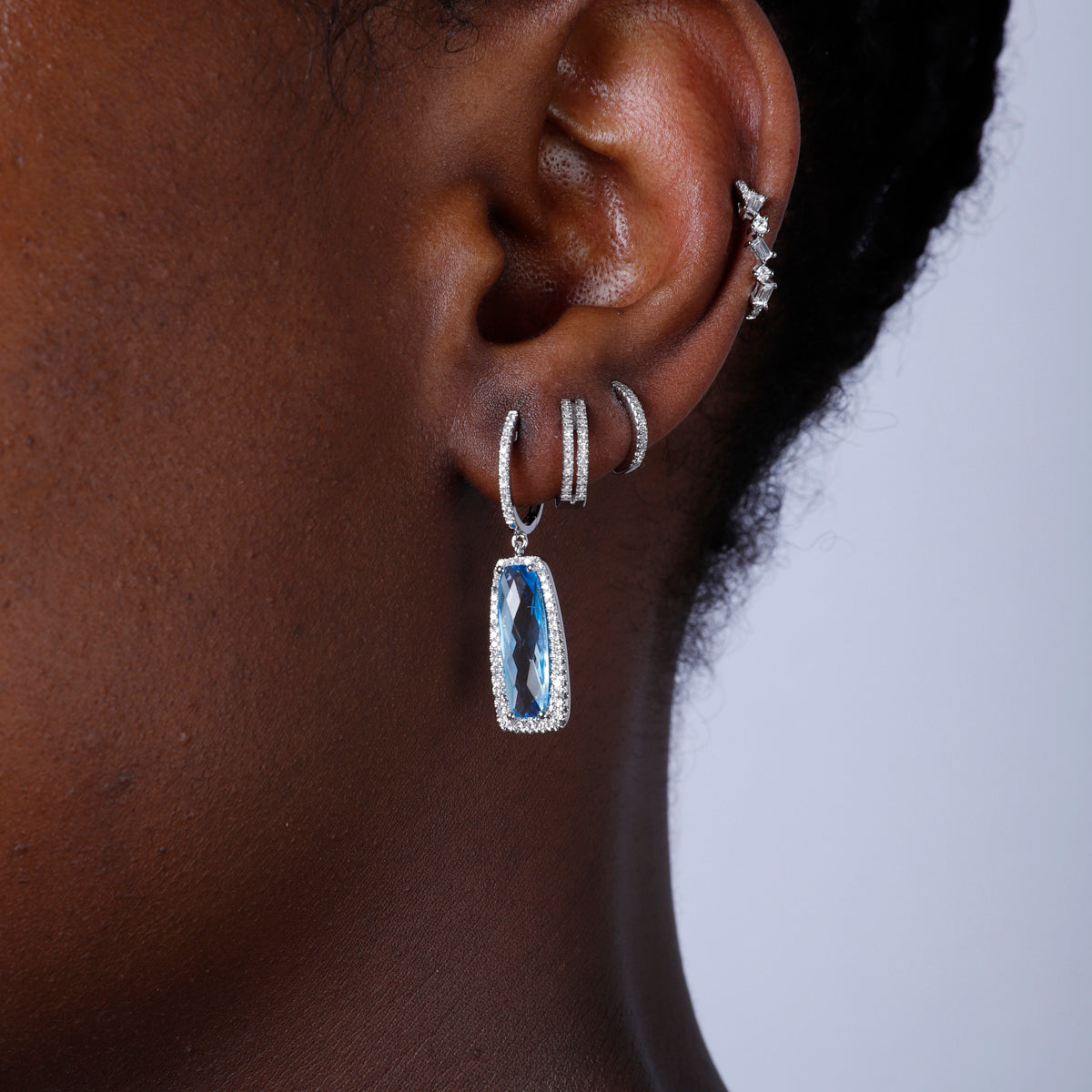 Dangle Gemstone Earrings with a halo of diamonds illuminating the playful gem for any special event