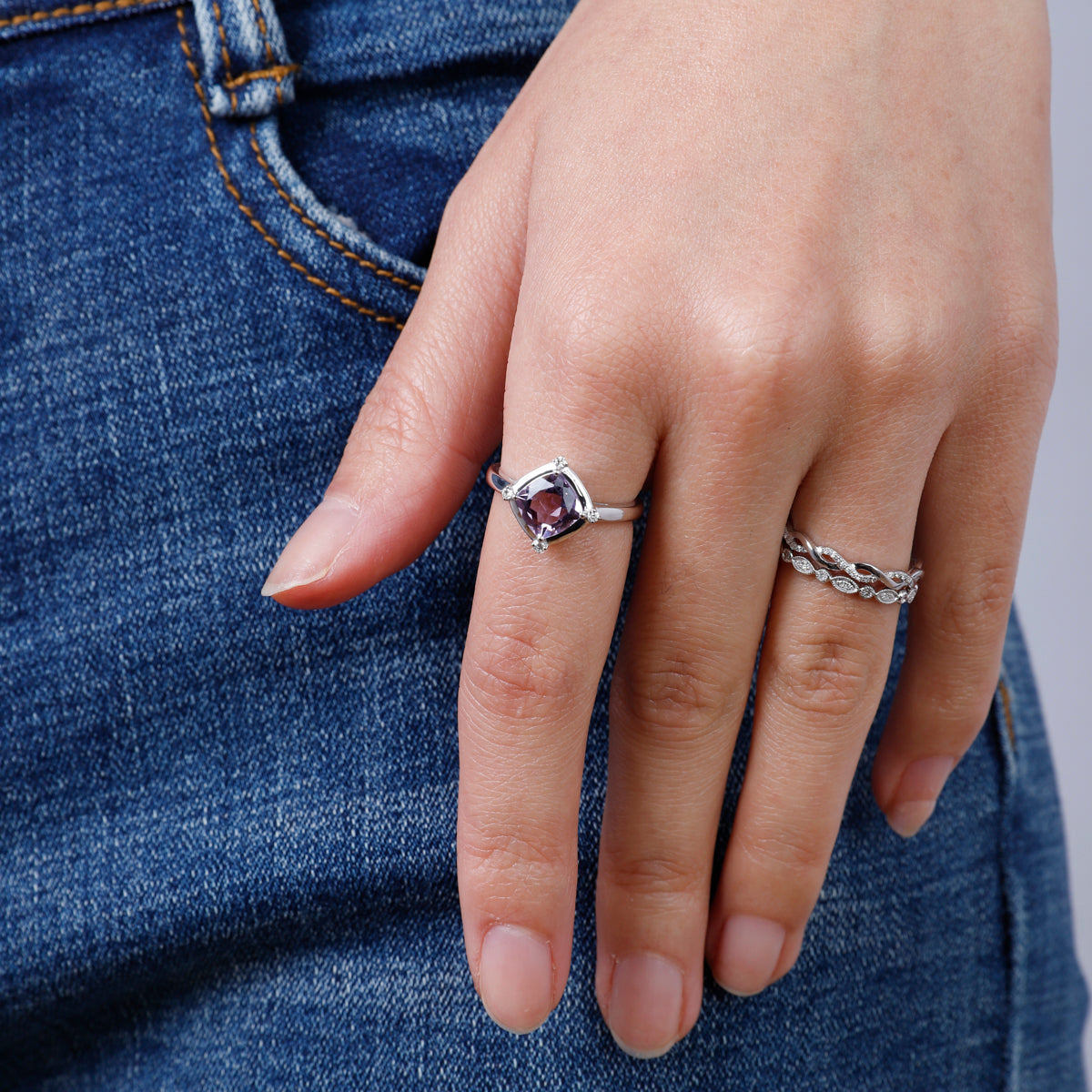 Stunning ring with a gemstone at an angle with diamonds at each corner to accentuate its color. 
