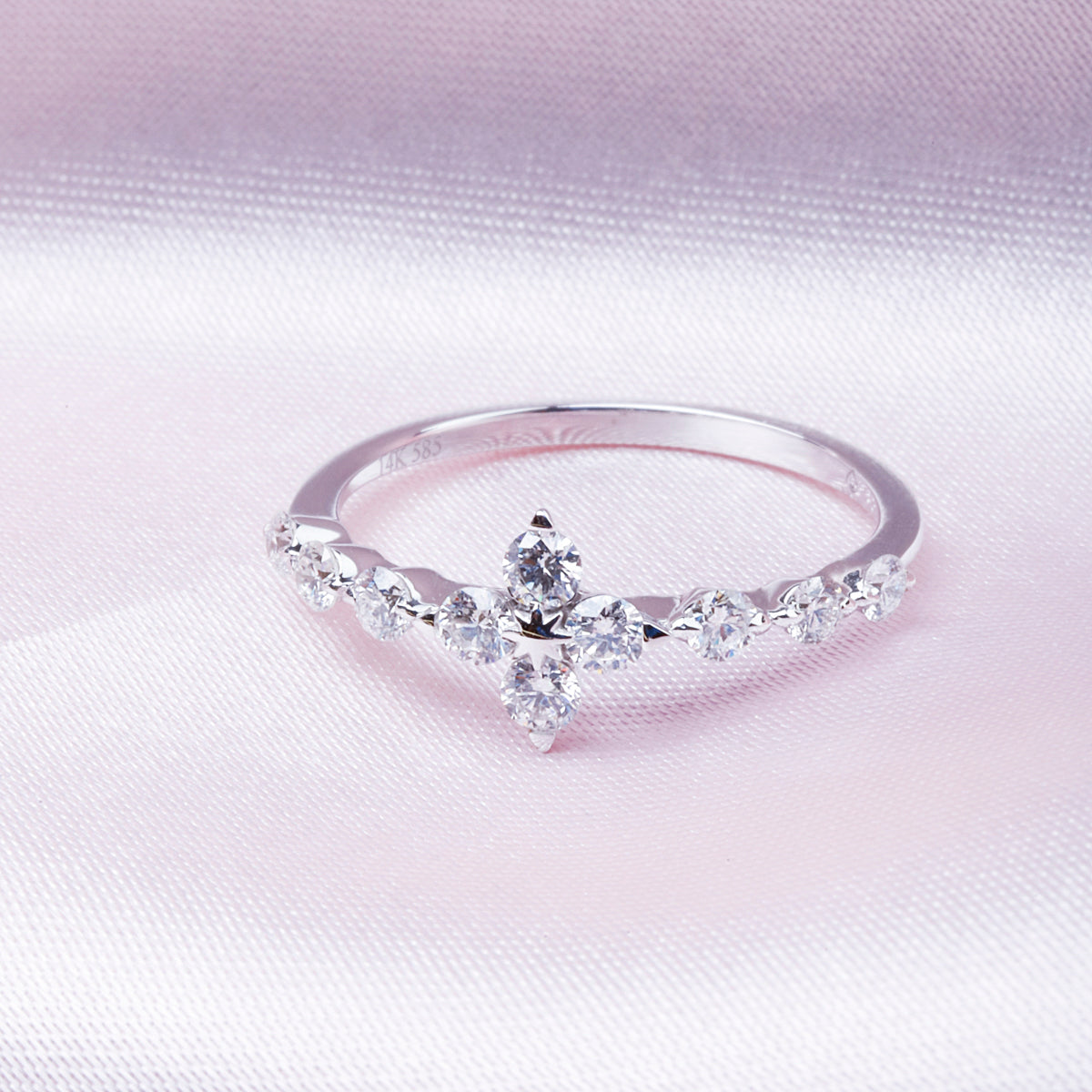 Radiant cluster floral half band diamond ring is enhanced with a row of shimmering diamonds