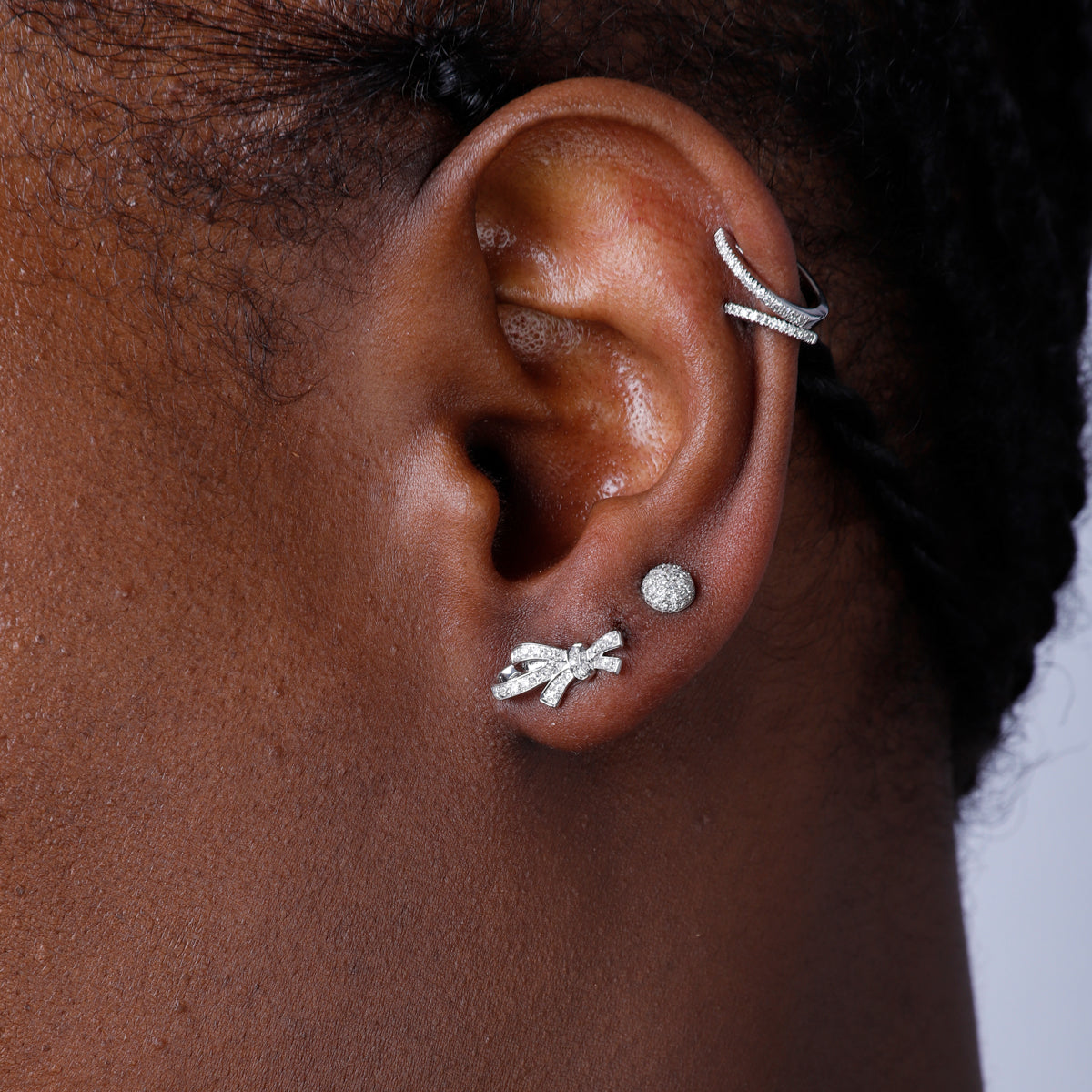 Diamond bow studs with pave set round diamonds. Crafted with fine details of intertwined bows.