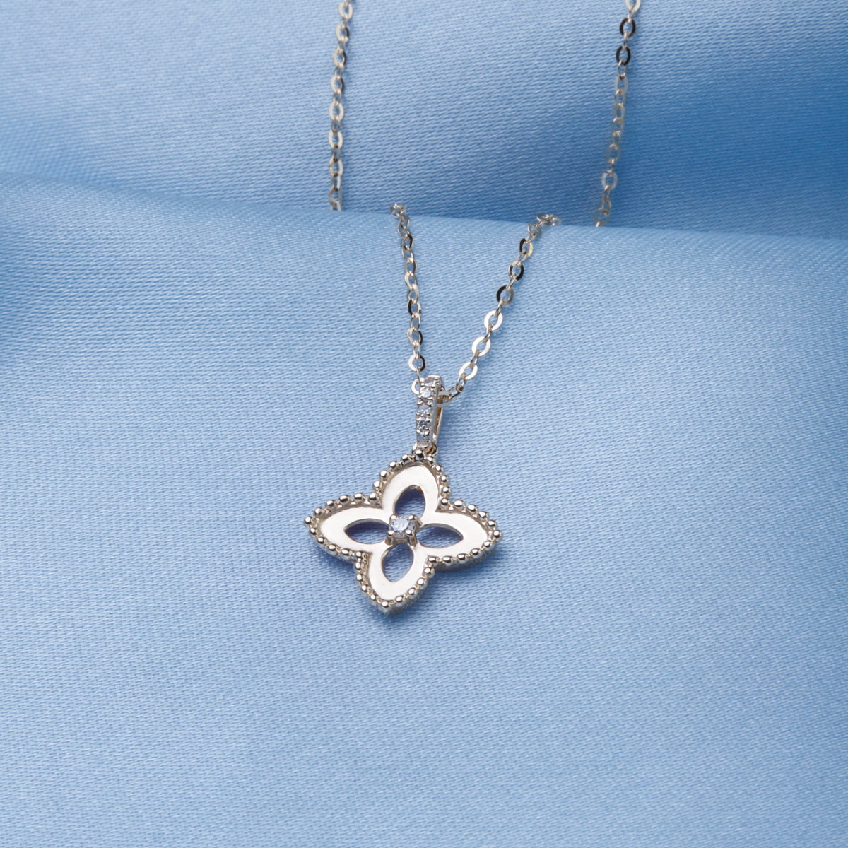 Clover design symbolizes good fortune. Embellished with sparkling diamonds and stunning beading.