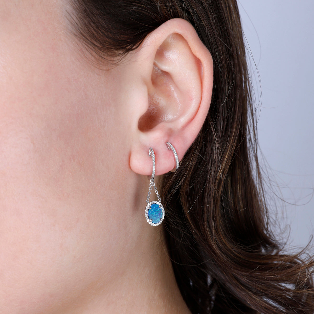 Opal Earring with a luxurious diamond halo held together by chains to flaunt opal by a dangle. 