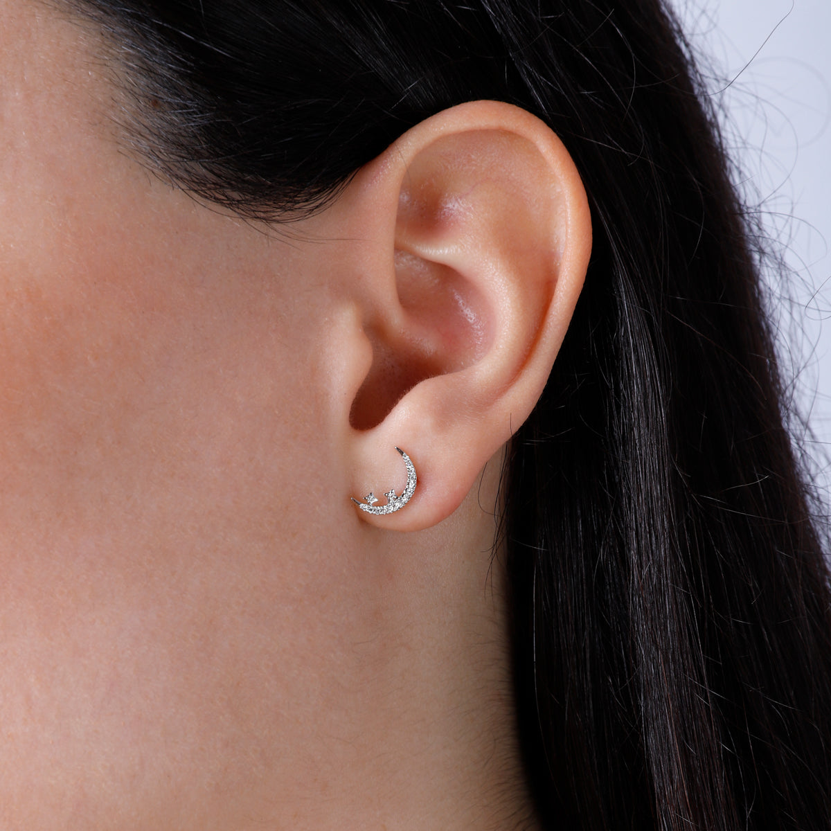 Diamond moon studs with shiny diamonds to elevate the added star design. 