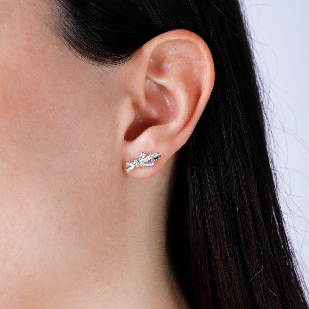 Diamond bow studs with pave set round diamonds. Crafted with fine details of intertwined bows.