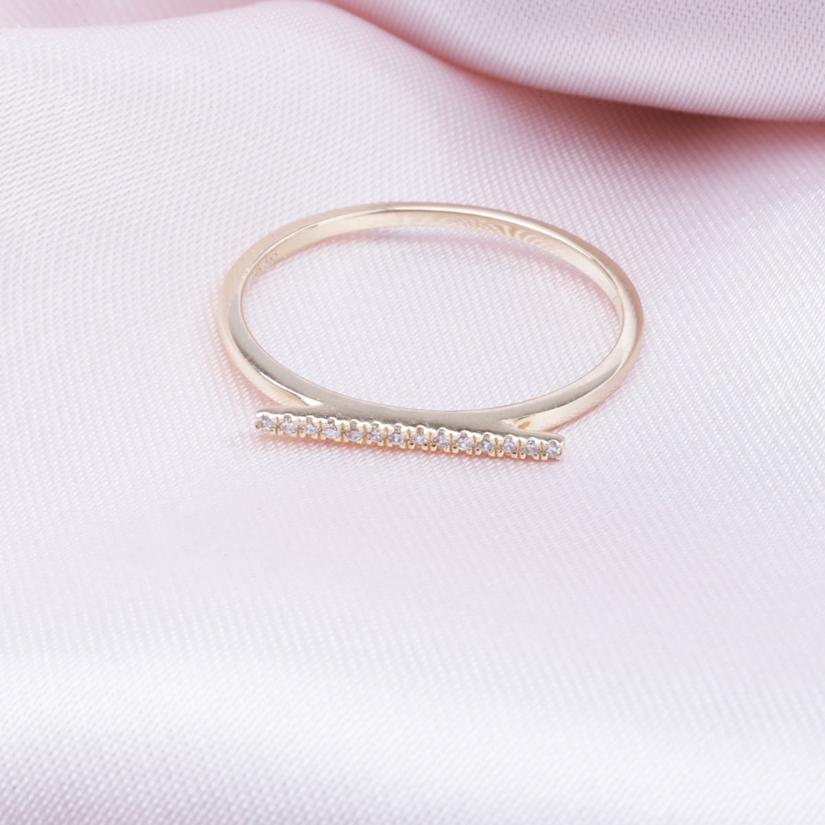 Crafted with sleek sophistication. Golden bar of alluring diamonds, showcased in polished 14K ring.