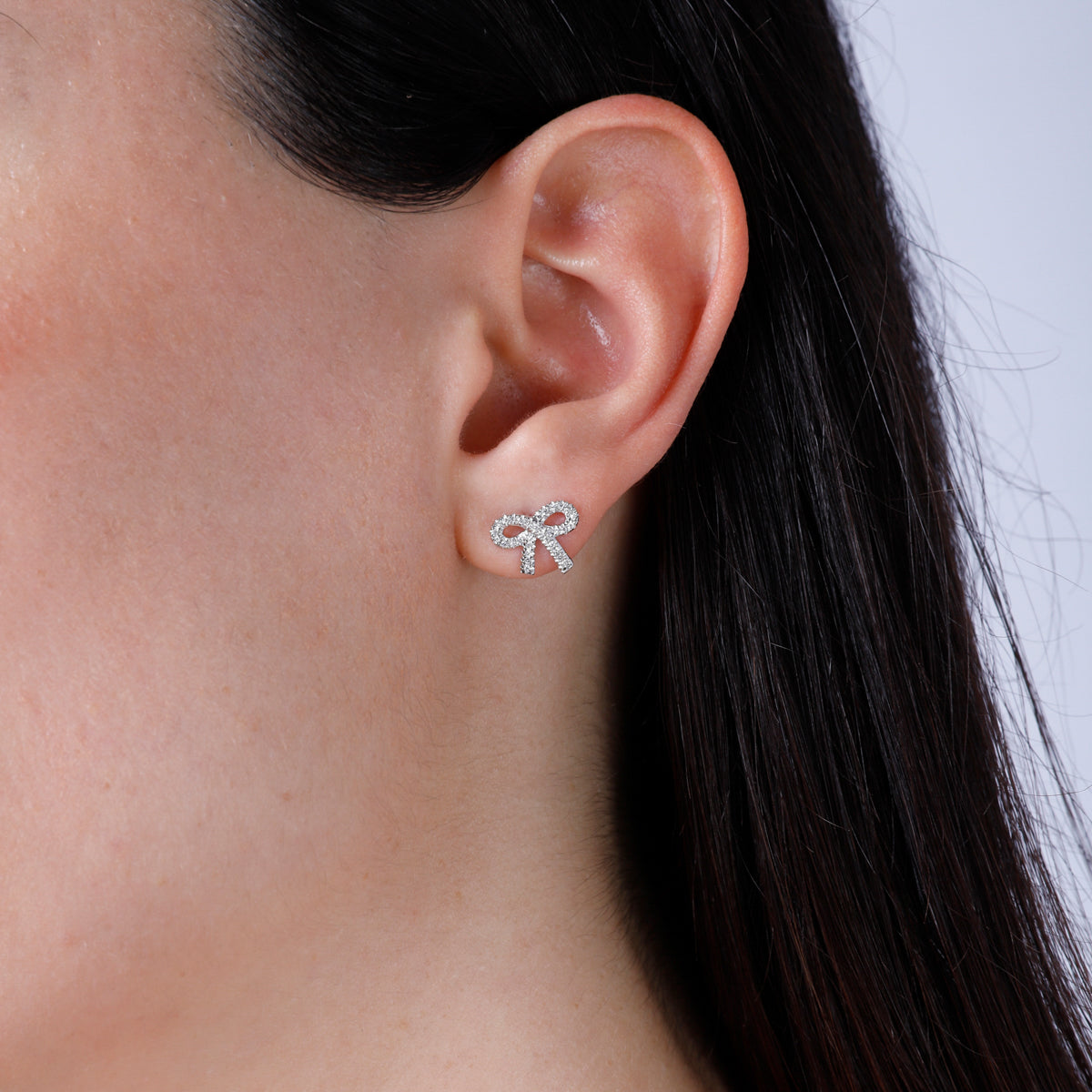 Simple and elegant bow studs with diamonds all around. Secure fitting, perfect for everyday. 