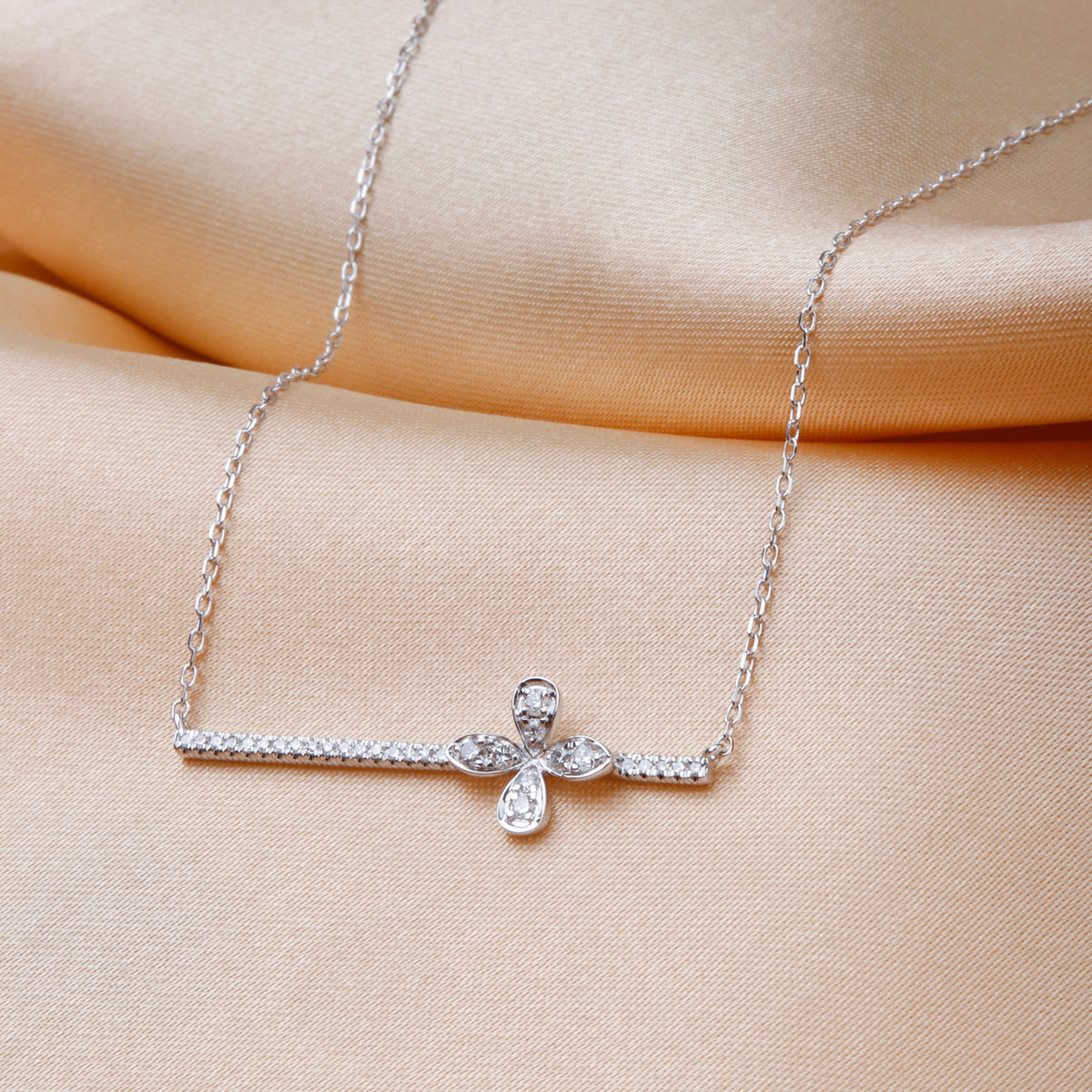 Intricate clover on a sleek bar and delicate chain offering a variety of style to your everyday