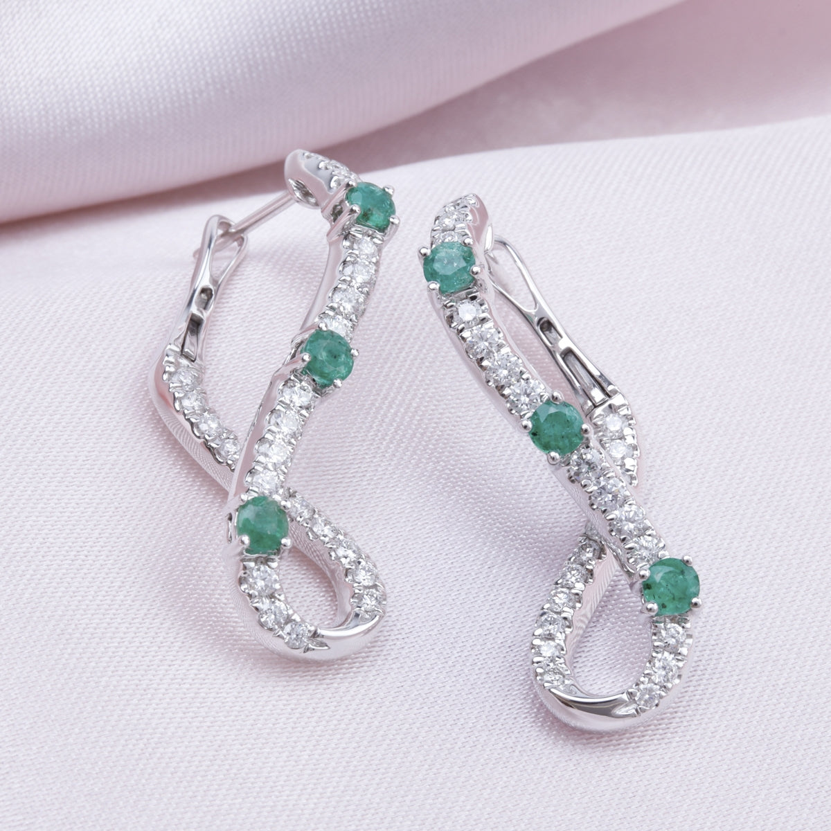 Discover elegance with Abstract Infinity Whirl Earrings, with Diamond and Precious stones. 