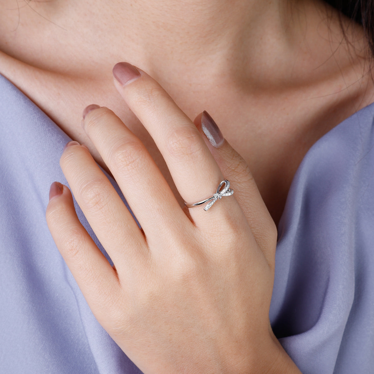 Bow diamond ring is a luminous gold band and a dainty bow set with multiple diamonds.