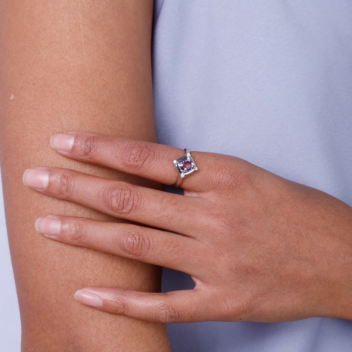 Stunning ring with a gemstone at an angle with diamonds at each corner to accentuate its color. 