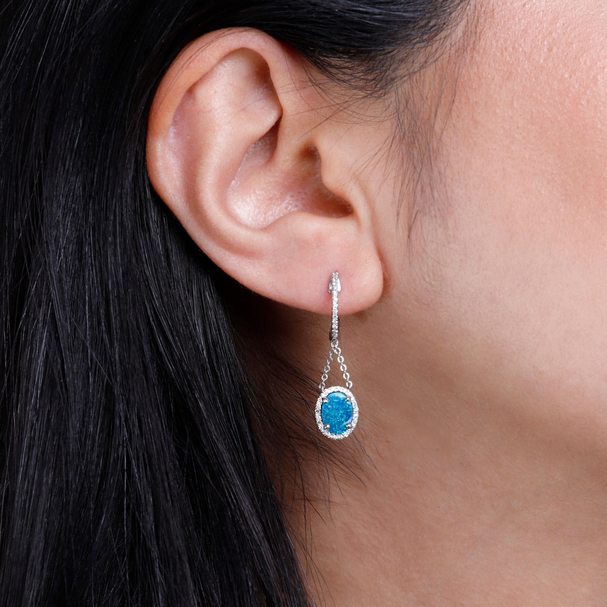 Opal Earring with a luxurious diamond halo held together by chains to flaunt opal by a dangle. 
