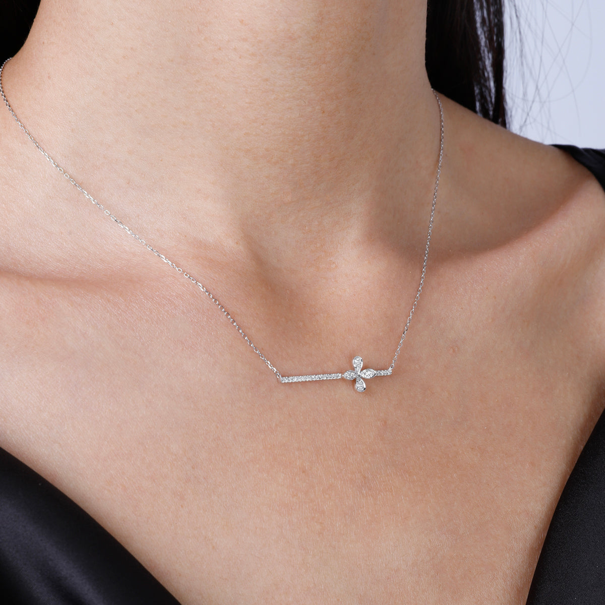 Intricate clover on a sleek bar and delicate chain offering a variety of style to your everyday