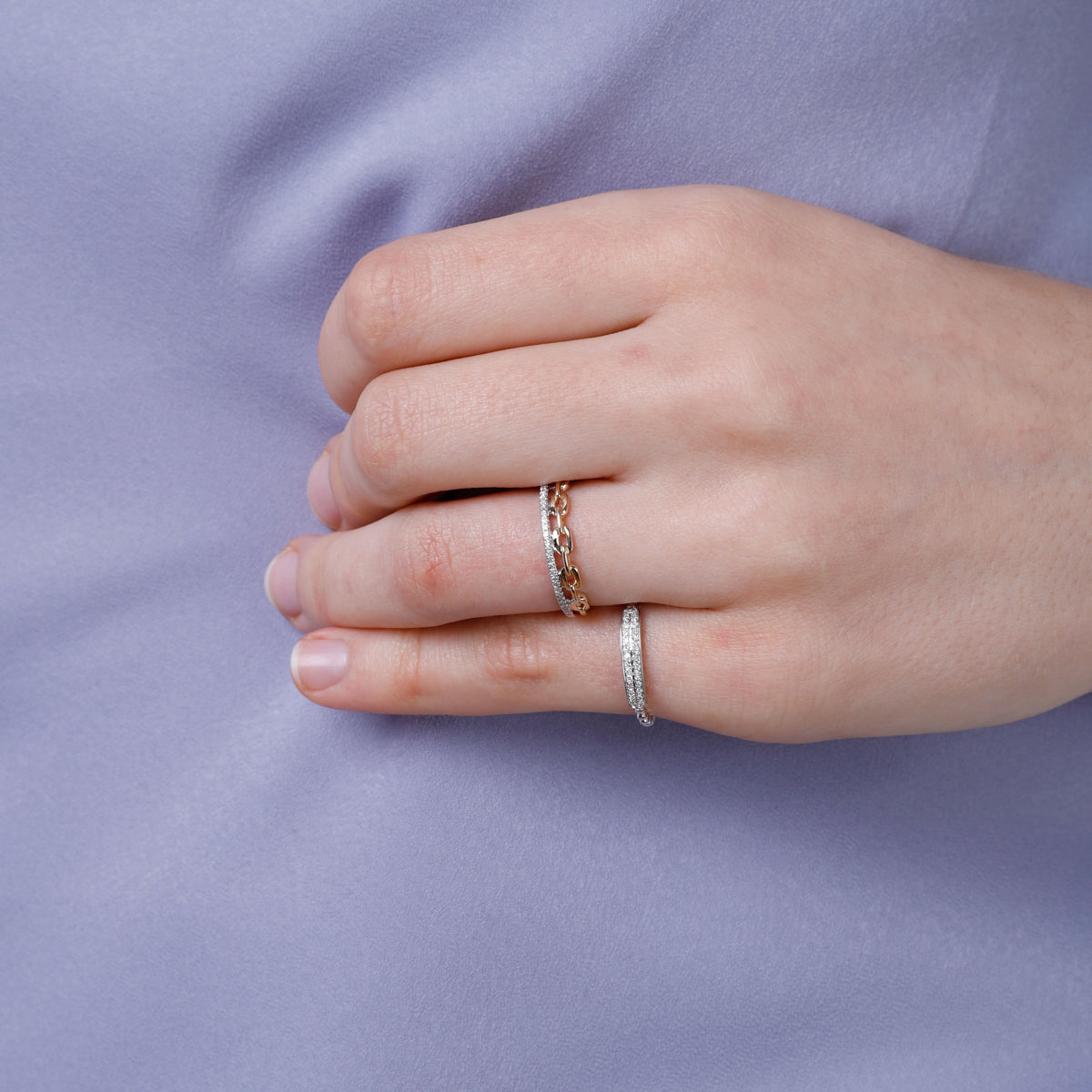 Featuring a diamond at the center, accented by dazzling bar settings and linked to an elegant chain.