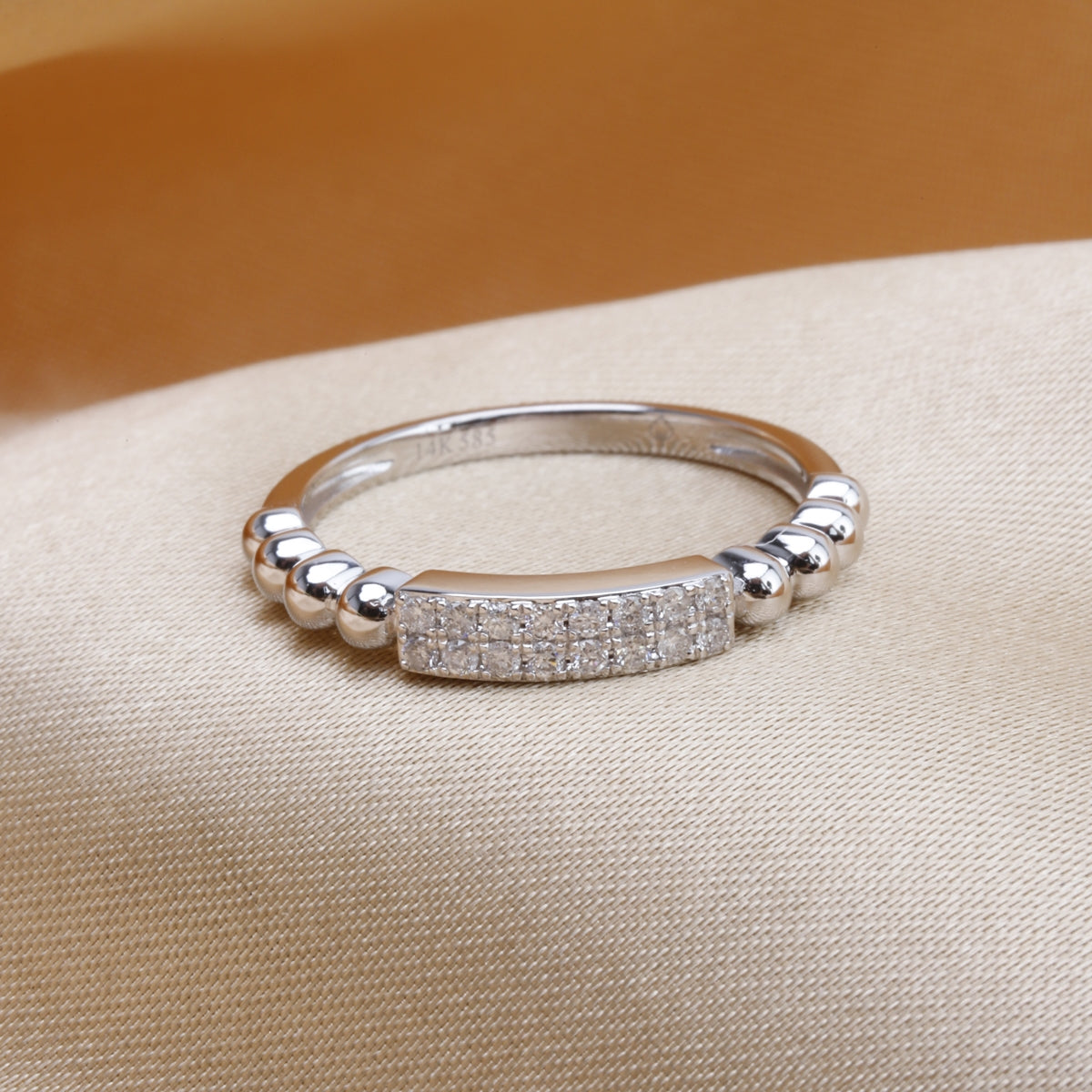 A radiant diamond bar surrounded by a bead band. Infuse edgy sophistication.