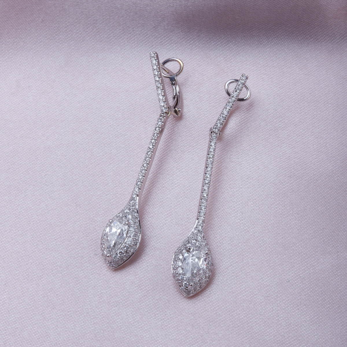 18k Diamond Drop Earrings with a pave setting enhancing the center diamond to stand out. 