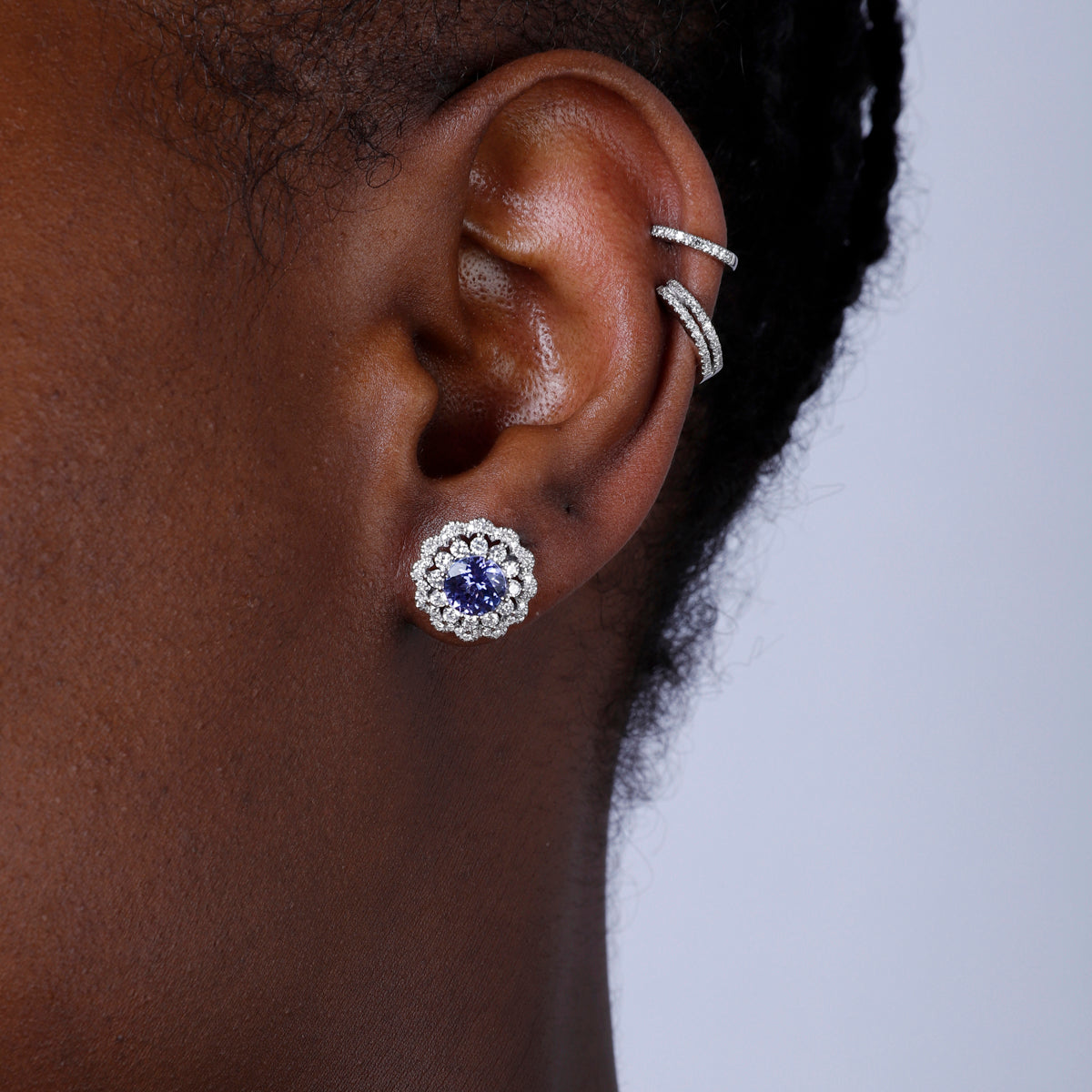 Inspired bloom studs with a charming precious stone surrounded by diamonds. Stunning jewelry