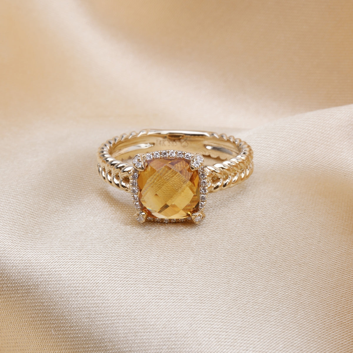 Braided Halo Ring, gemstone with a golden braided band symbolizing unity and strength. Modern twist.