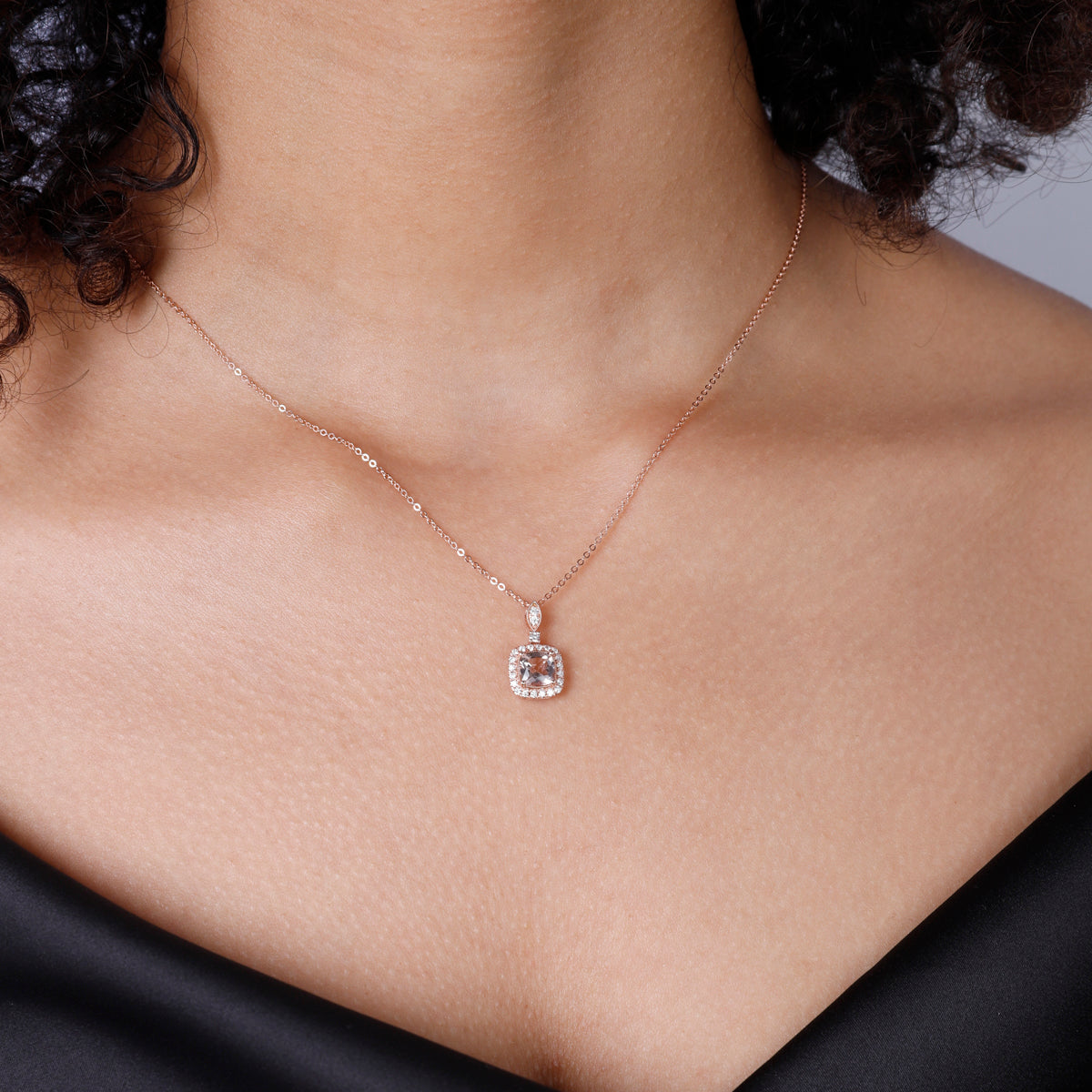 Cushion Cut Necklace displaying an intricate arrangement of diamonds and a center precious stone