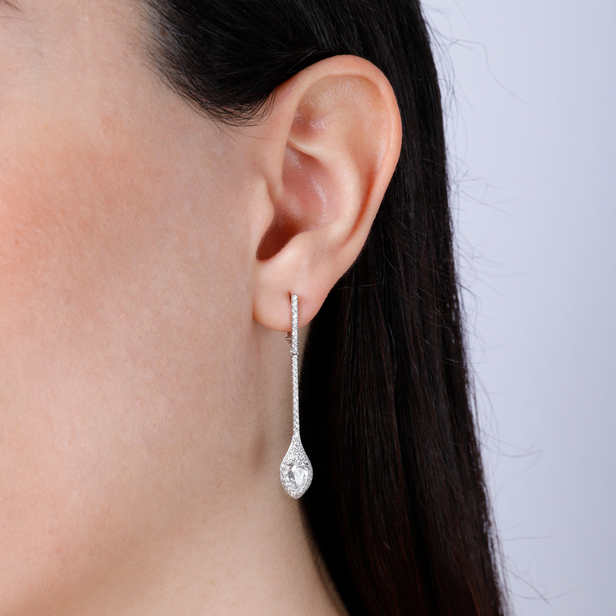 18k Diamond Drop Earrings with a pave setting enhancing the center diamond to stand out. 