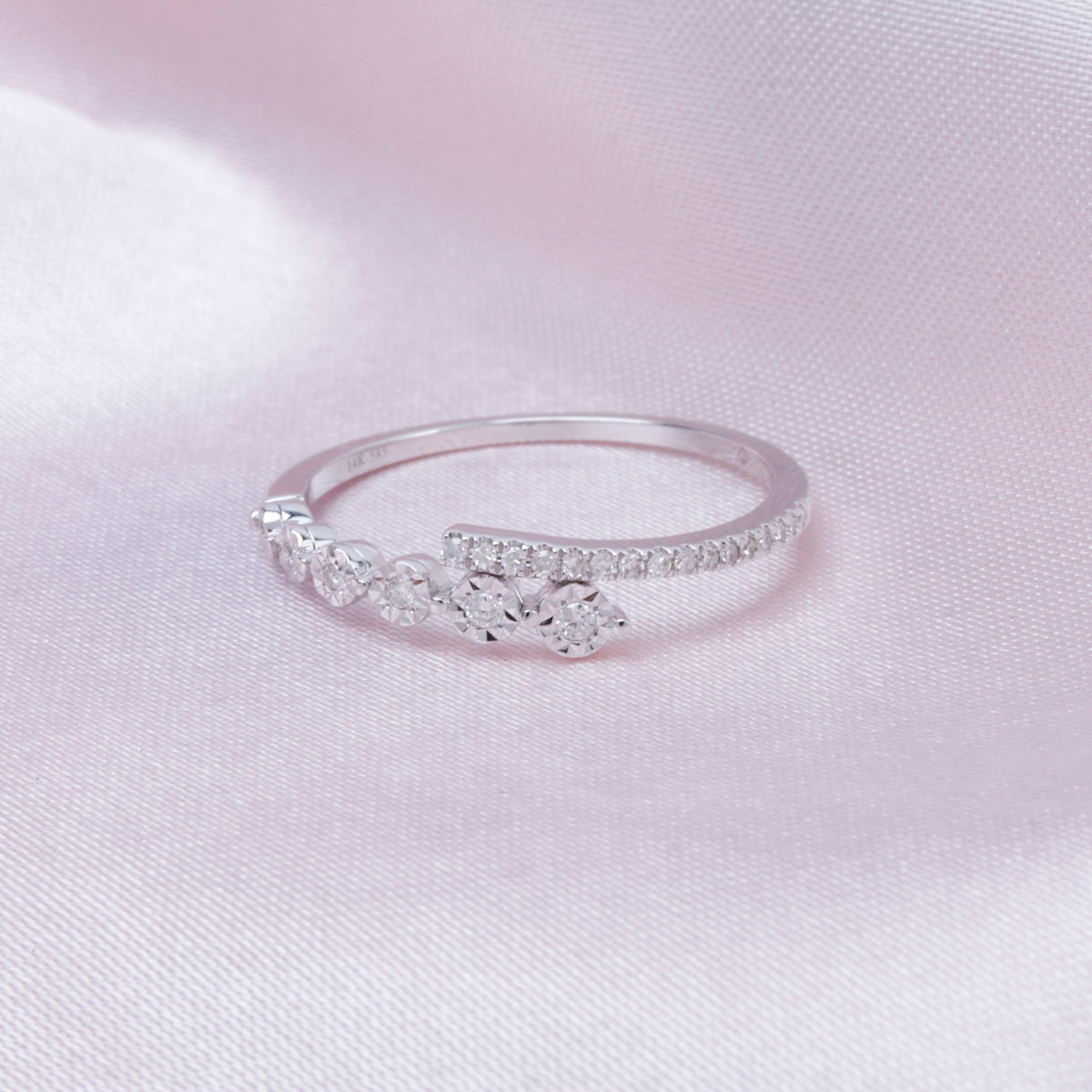 Round delicate diamonds collide with a bar of diamonds creating a stunning work of art. 