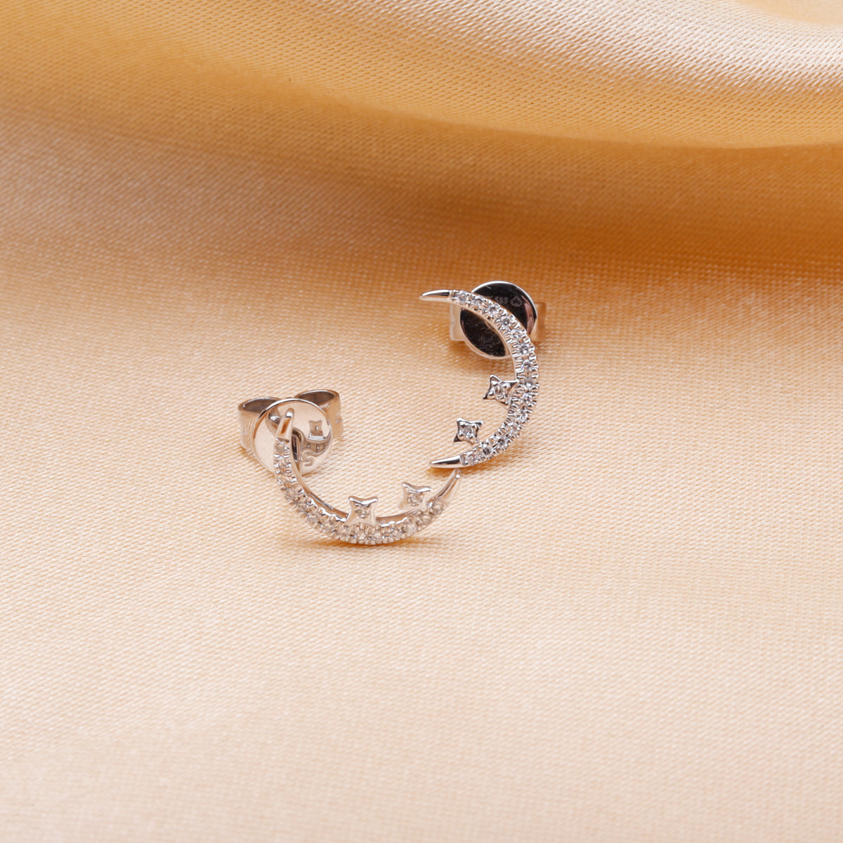 Diamond moon studs with shiny diamonds to elevate the added star design. 