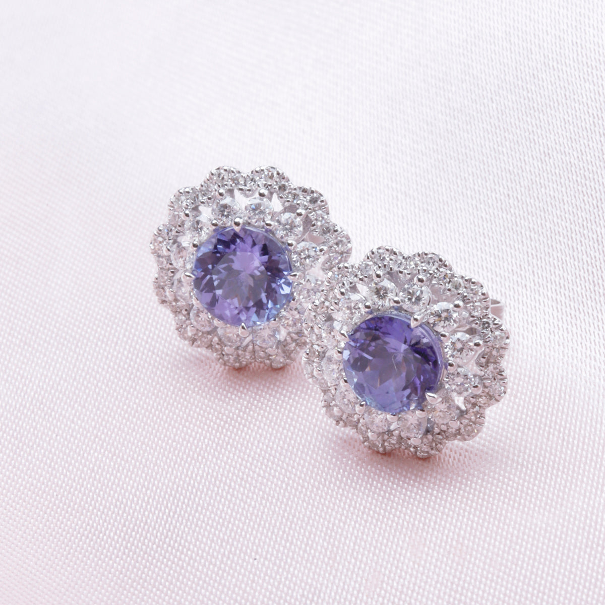 Inspired bloom studs with a charming precious stone surrounded by diamonds. Stunning jewelry