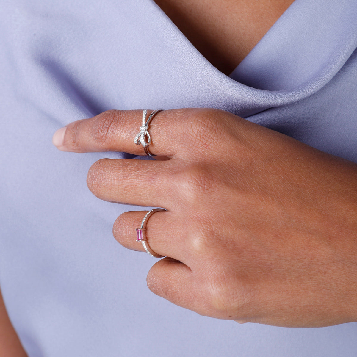 Bow diamond ring is a luminous gold band and a dainty bow set with multiple diamonds.