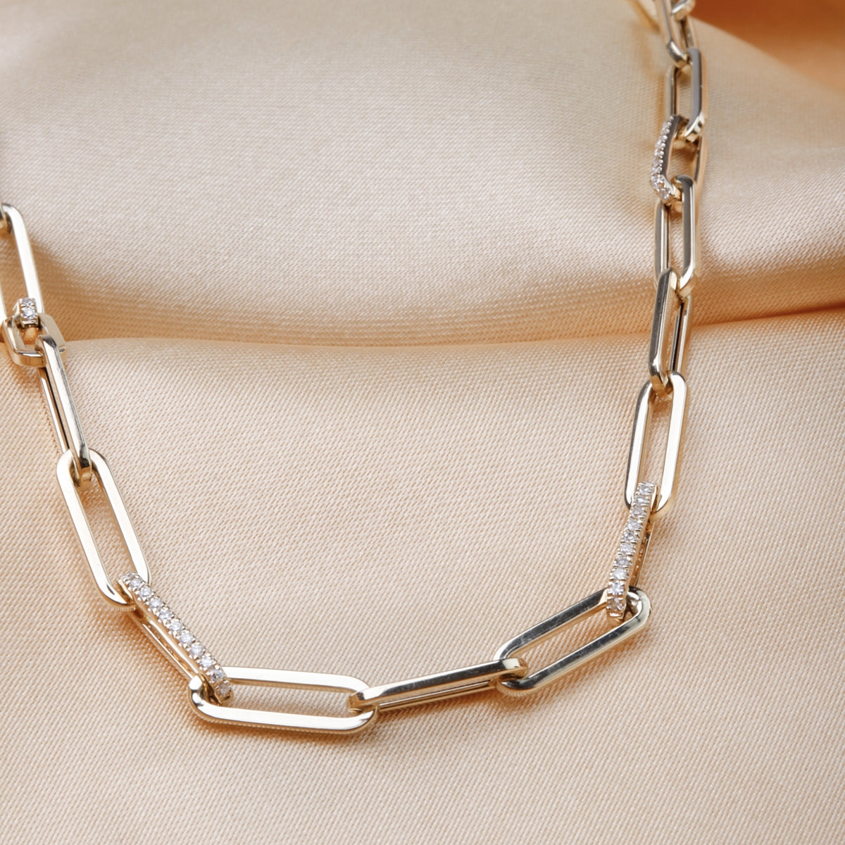 Diamond chain necklace features strand of round diamonds, set in row down center of a classic chain