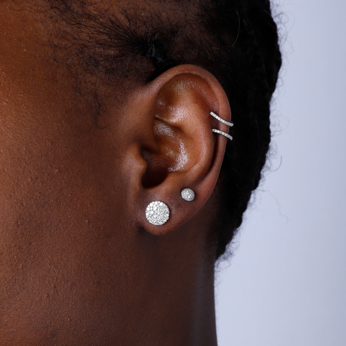 Cluster earrings feature a classic round diamond shape, held together with a platinum prong setting.