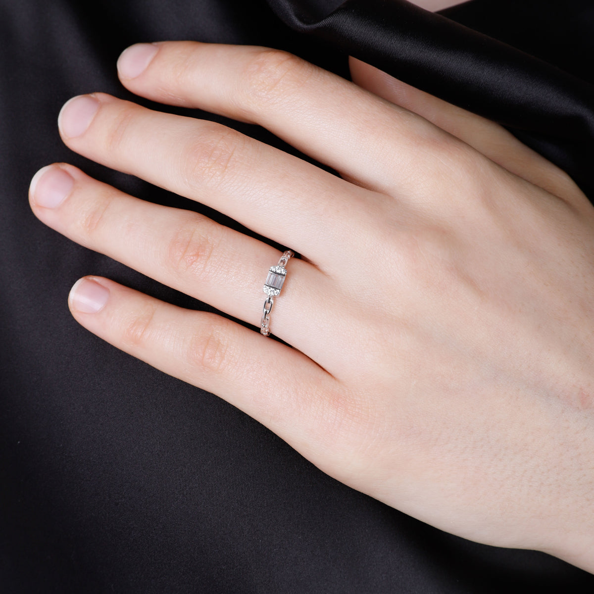 A dainty statement piece with a center baguette cut diamond with a chain link design. 