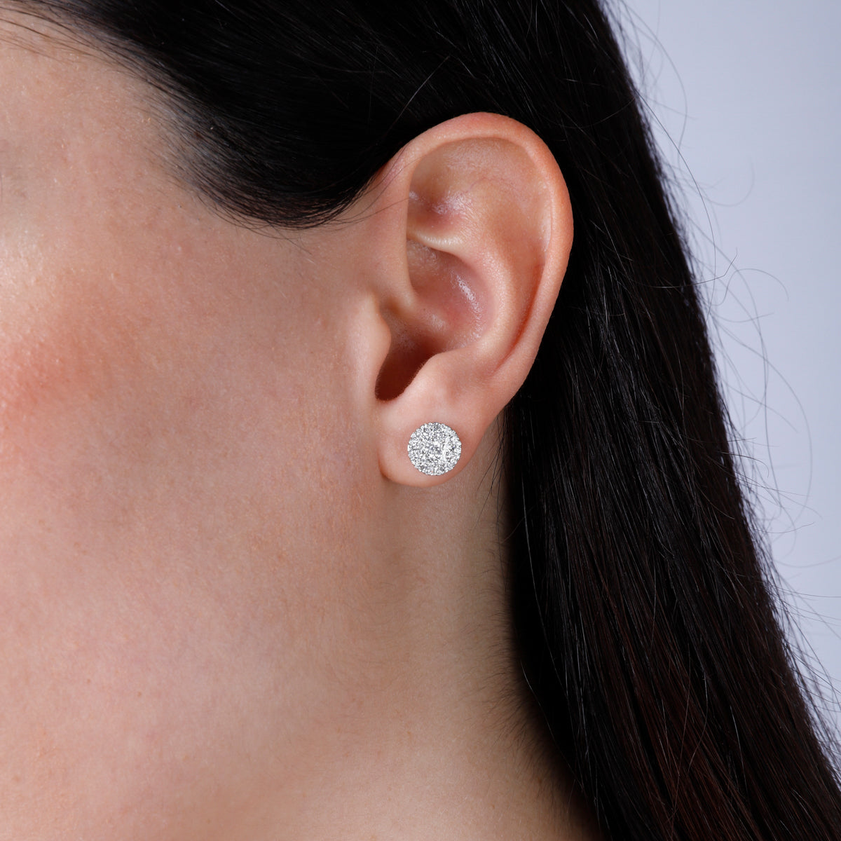 Cluster earrings feature a classic round diamond shape, held together with a platinum prong setting.
