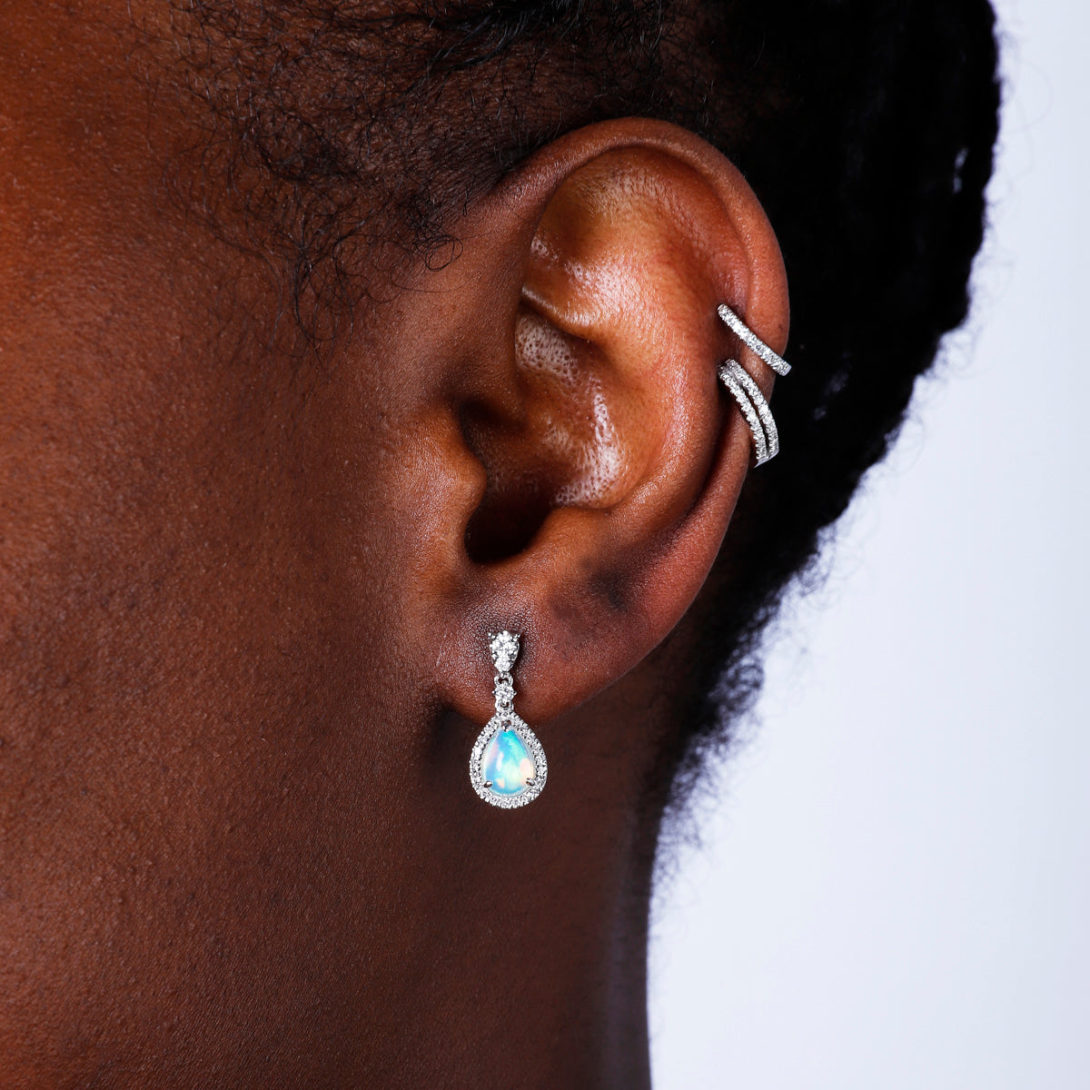 Opal Earrings in a dangle design with a diamond halo. Timeless and effortless beauty. 