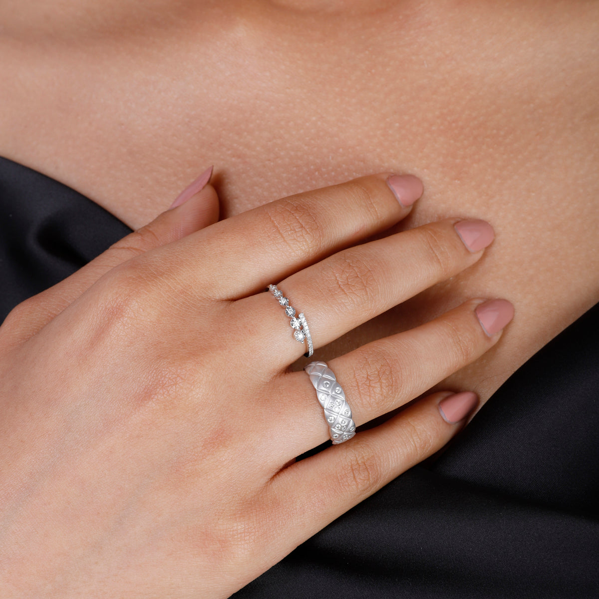 Round delicate diamonds collide with a bar of diamonds creating a stunning work of art. 