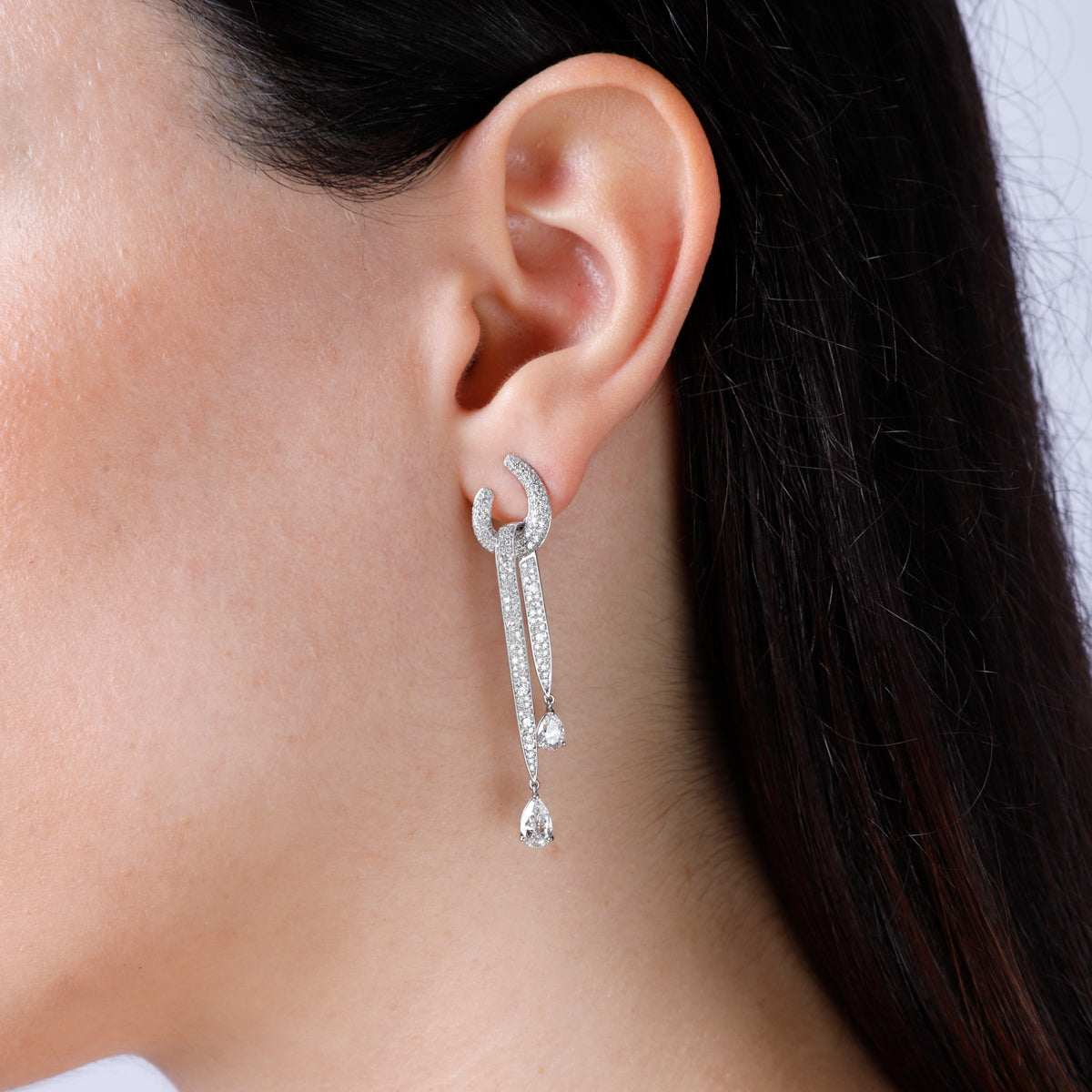 Bold diamond dangle earrings embellished with pear shaped diamonds and other pavé diamonds. 