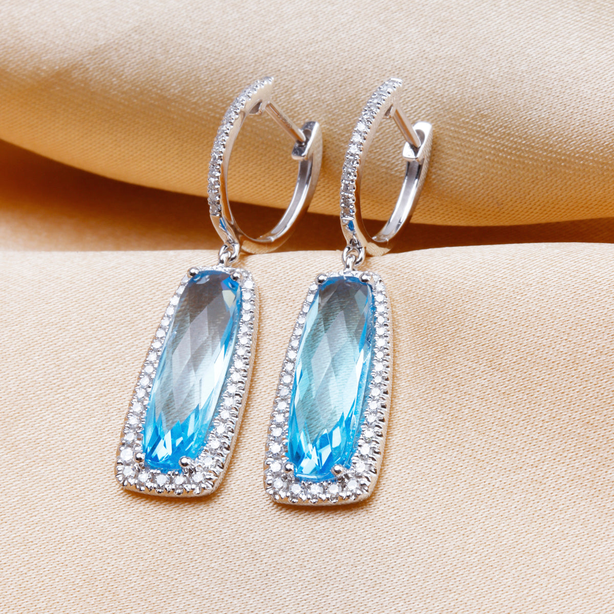 Dangle Gemstone Earrings with a halo of diamonds illuminating the playful gem for any special event