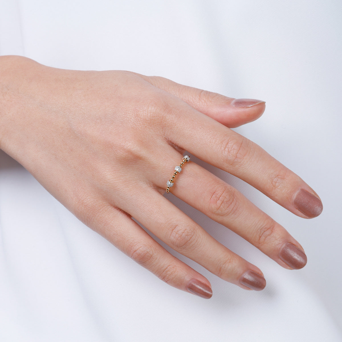 Beaded diamond stacking band features a row of sparkling diamonds perfectly placed around the ring.