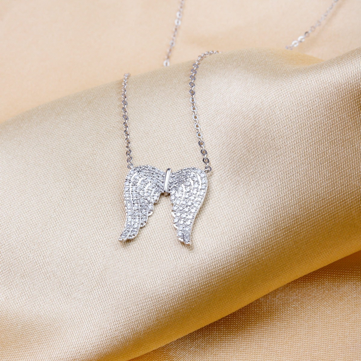 Angel Wings Necklace features handcrafted intricately detailed diamond angel wings.