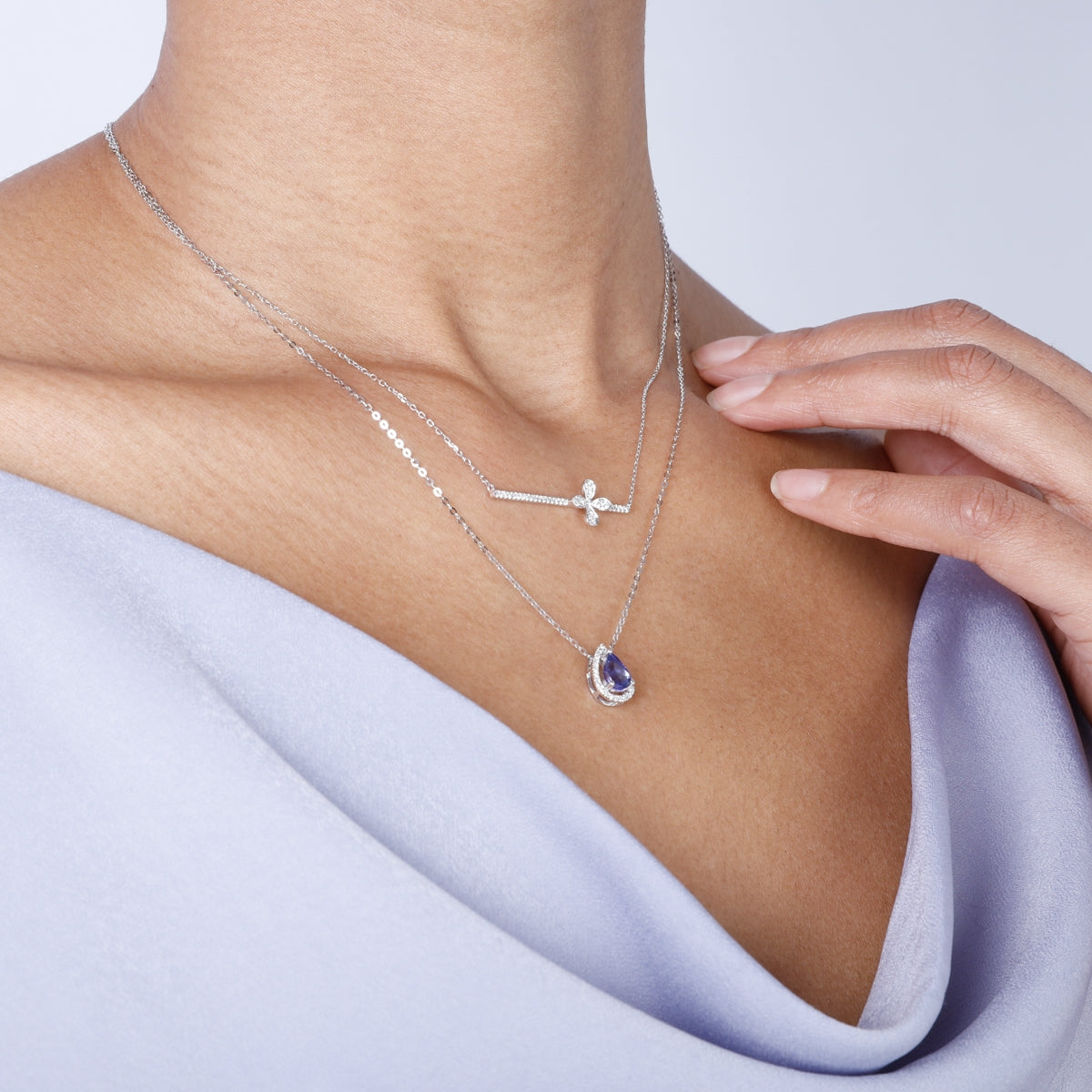 Intricate clover on a sleek bar and delicate chain offering a variety of style to your everyday