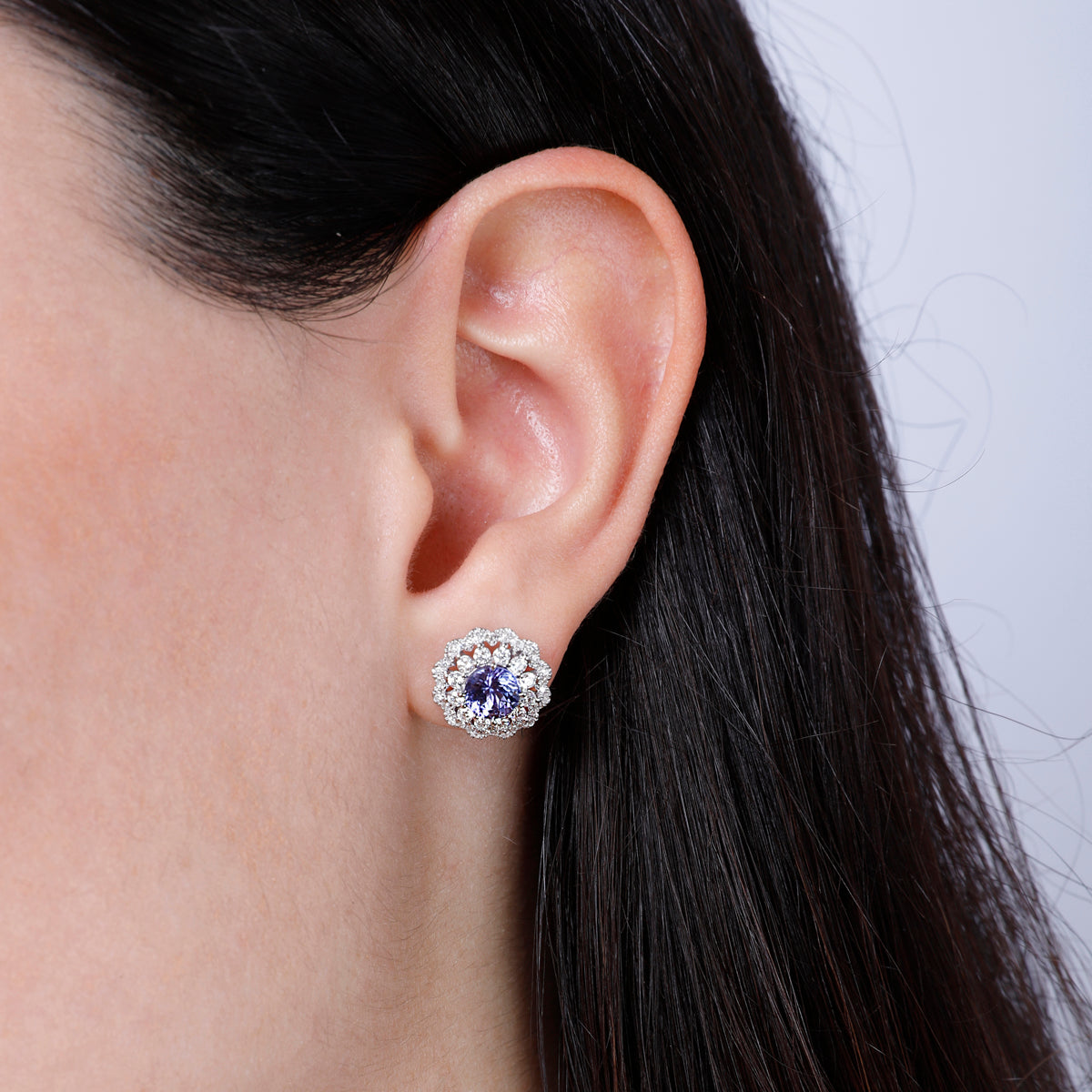 Inspired bloom studs with a charming precious stone surrounded by diamonds. Stunning jewelry