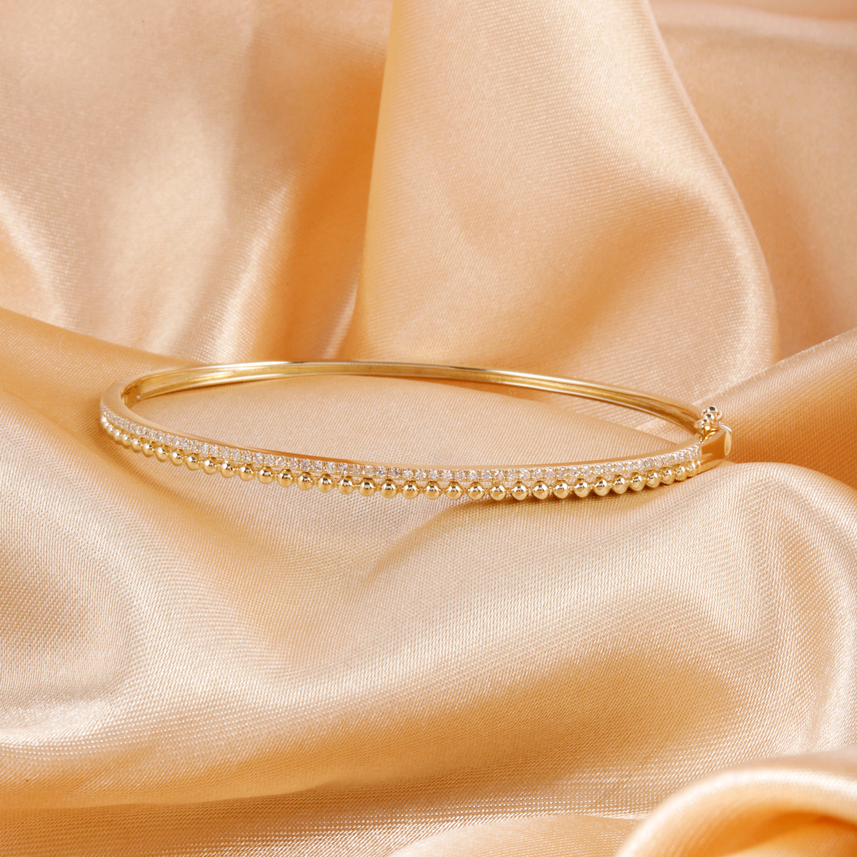 Beaded Gold Bangle features beaded accents that radiate classic charm. Add a touch of sophistication